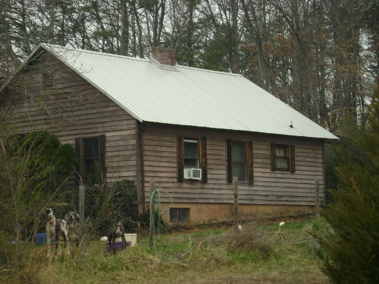 White metal roof on an old wood sided farmhouse, from a Metal Roof Installation job in Port Royal